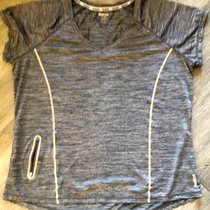 Reebok 1X  a running shirt with a small pocket on the side for keys.